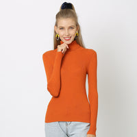 Woman wearing oversized solid colour turtleneck sweater