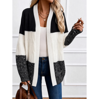 Woman wearing oversized colour block cable knit cardigan