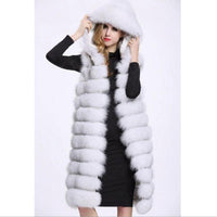 Woman wearing long black and white faux fur vest